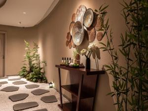 a room with a table with plates on the wall at CLASSYC Hotel in Hanoi