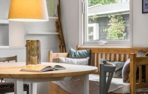 a dining room with a table with a book on it at Awesome Home In Gilleleje With Kitchen in Gilleleje