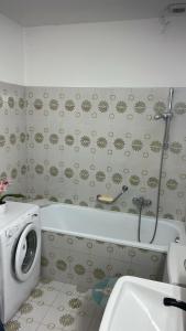 a bathroom with a tub and a toilet and a sink at Dreamapartment 4 Roomlake in Lugano +12 photos