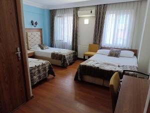 Postel nebo postele na pokoji v ubytování Şirin Hotel