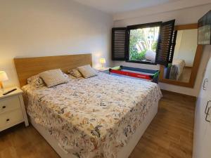 a bedroom with a large bed and a window at Vivienda Vacacional frente al mar Playa del Aguila in Playa del Aguila +39 photos