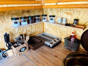 a kitchen with shelves and utensils on a wall at Tnak Dream House in Kapan