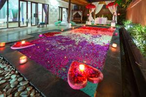 a room with a large pool of red and purple lights at Private Pool Villas in Kuta +60 photos
