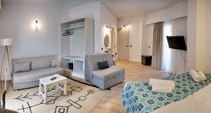 a living room with a couch and a chair at Aquamare Molyvos hotel adults only in Mithymna