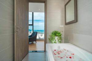 a bathroom with a bath tub with a plant in it at Areca Hotel Nha Trang in Nha Trang