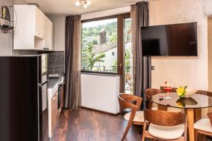 a small kitchen with a table and a window at Enika Hotel in Tryavna