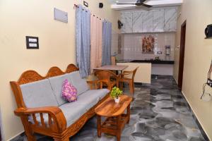 a living room with a couch and chairs and a table at jkpalace in Yelagiri
