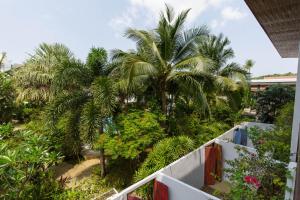 a view of palm trees from a balcony at Greenlight Fisherman's Village Resort & Café in Koh Samui 
