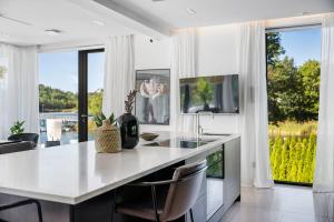 a kitchen with a white counter and a large window at Lyxig villa i Solsidan in Stockholm