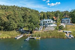 an aerial view of a house and boats in the water at Lyxig villa i Solsidan in Stockholm