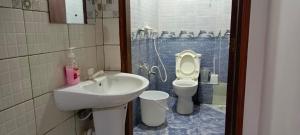 a bathroom with a sink and a toilet at One Bedroom Bamburi in Mombasa +9 photos