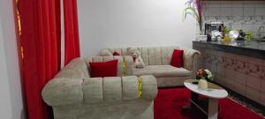 a teddy bear sitting on a couch in a living room at One Bedroom Bamburi in Mombasa