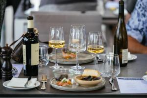 a table topped with glasses of wine and food at Strandhotel Klinten in Rødvig