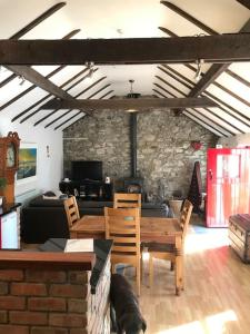 a living room with a table and chairs and a couch at Stone Wall Cottage in Castlewellan
