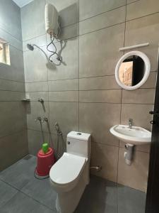 a bathroom with a toilet and a sink at Full moon Residency in Ernakulam
