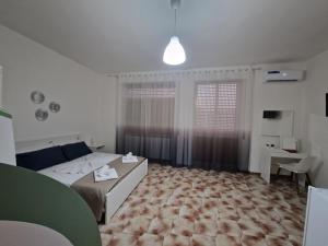 a bedroom with a bed and a desk and a window at Cosy Corner in Tollo