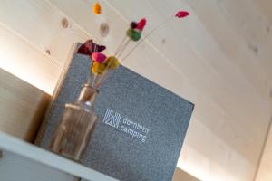 a vase with flowers in it sitting on a shelf at Apartment am Camping Dornbirn - 214 Staufen in Dornbirn