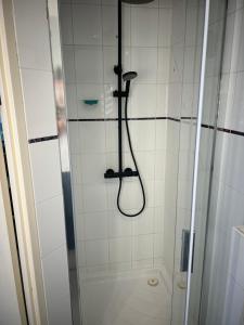 a shower with a shower head in a bathroom at Anda in Zandvoort