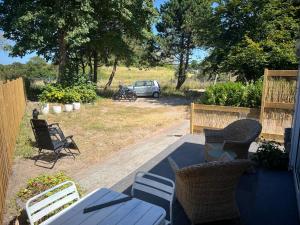 a patio with chairs and a table and a car at Anda in Zandvoort