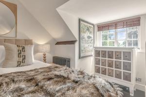 En eller flere senge i et værelse på Matchstick Cottage