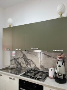 a kitchen with a stove and a counter top at Al canto del Muezzin - Apartment in Mazara del Vallo