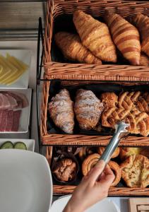 a person holding a knife in front of a rack of bread at Montagu Place Hotel in London
