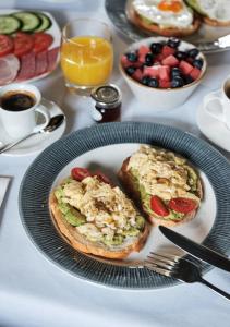 a plate of food with toast and fruit on a table at Montagu Place Hotel in London +52 photos