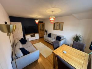 a living room with a couch and a table at Cosy Shared Flat - Self Check-In, Free Street Parking in Leavesden Green