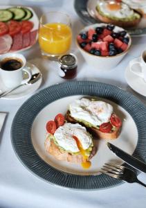 a plate of breakfast food with eggs and fruit on a table at Montagu Place Hotel in London
