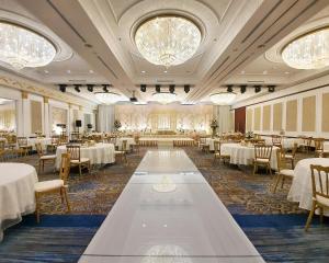 a banquet hall with tables and chairs and chandeliers at Crowne Plaza Jeddah by IHG in Jeddah +109 photos