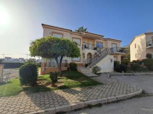 a large house with a tree in front of it at Apartamento Oásis Parque 1 in Portimão
