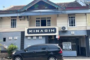 a black van parked in front of a building at Hotel Kinasih Yogyakarta in Yogyakarta