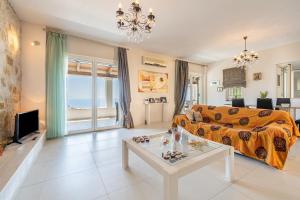 a living room with a couch and a table at Villa Salvia in Katávolos