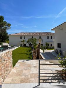 a house with a fence and a yard at Villa Jérémy in Sanary-sur-Mer