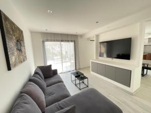 a living room with a couch and a flat screen tv at Villa Jérémy in Sanary-sur-Mer