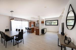 a dining room and living room with a table and chairs at Villa Jérémy in Sanary-sur-Mer