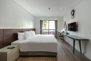 Postel nebo postele na pokoji v ubytování A25 Hotel - 18 Nguyễn Hy Quang