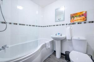 a white bathroom with a sink and a toilet at -F5GH- For relaxed & Cosy stay, Free Parking, WiFi in Leeds