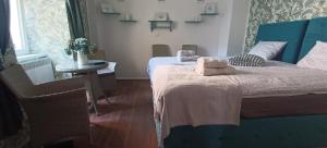 a bedroom with a bed and a table and a window at Apartman na Pekarske in Brno