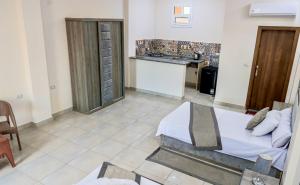 a bedroom with a bed and a kitchen with a table at الف ليله و ليله اكوا بارك بورسعيد in Port Said