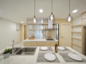 a kitchen with a sink and two plates on a counter at Southkey Mosaic by Antlerzone in Johor Bahru