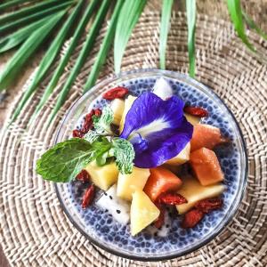 a bowl of food with a purple flower on it at Greenlight Fisherman's Village Resort & Café in Koh Samui 
