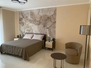 a bedroom with a bed and a chair at Anna House in San Marco dei Cavoti