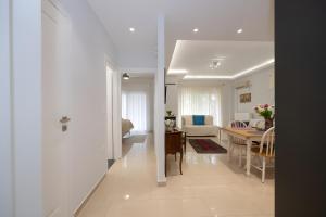 a living room and a dining room with a table at Lux 1-bedroom condo-L&L Refuge in Athens