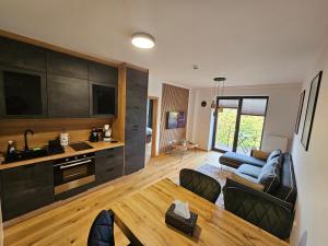 a living room with a couch and a table at DeLuxe apartmán s možností wellness Benecko 4 by AlkaTravel in Benecko