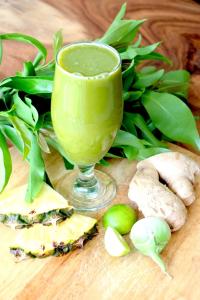 a glass of green juice and some vegetables on a table at Greenlight Fisherman's Village Resort & Café in Koh Samui 