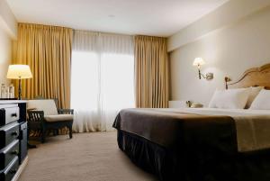 Cama ou camas em um quarto em Wyndham Garden Ushuaia Hotel del Glaciar