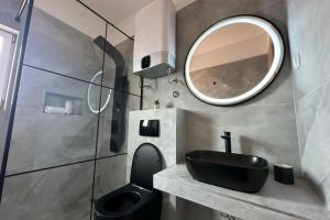 a bathroom with a black sink and a mirror at Apartment Ivan with Pool in Zagvozd