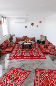a living room with red rugs on the floor at Villa Cartagena 2 in Brčko