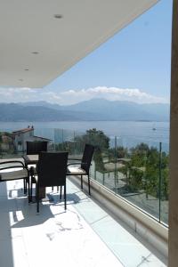 a balcony with chairs and a view of the water at Villa Le Grand Bleu in Đenovići